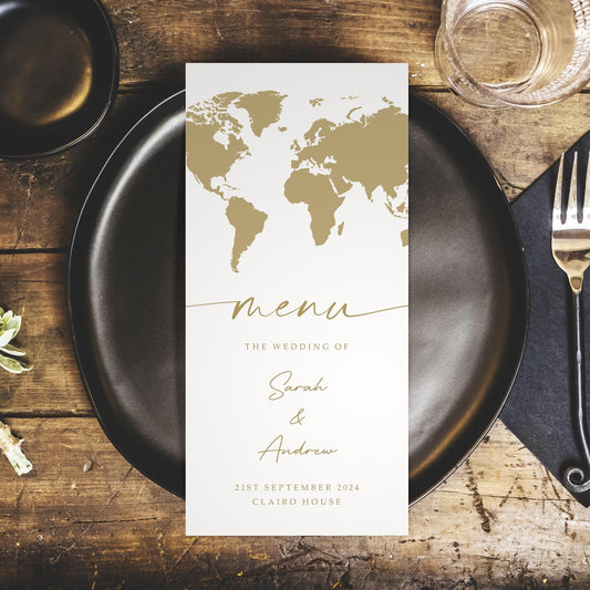 world map wedding menus with gold details matching passport invitations for destination wedding