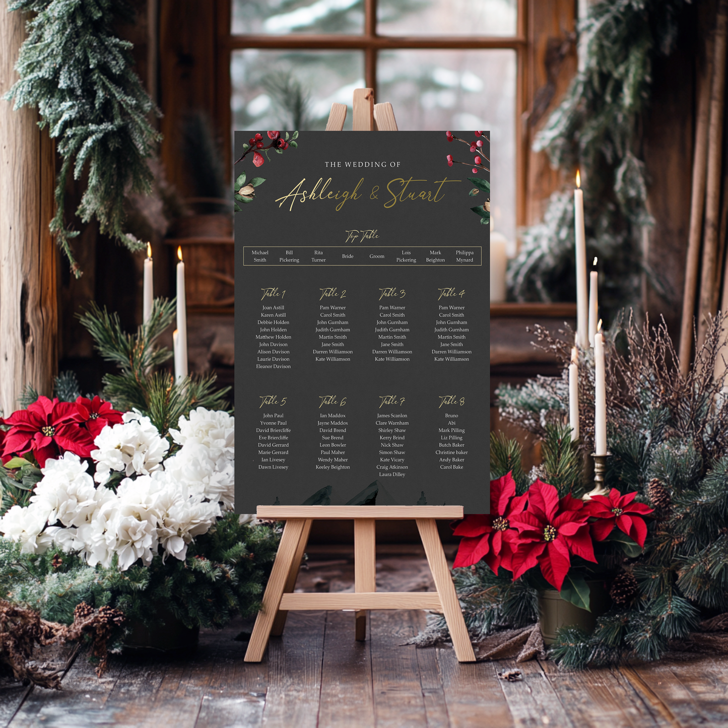 a wedding invitation board with a black background and gold text, surrounded by holiday decorations such as poinsettias and pine branches.