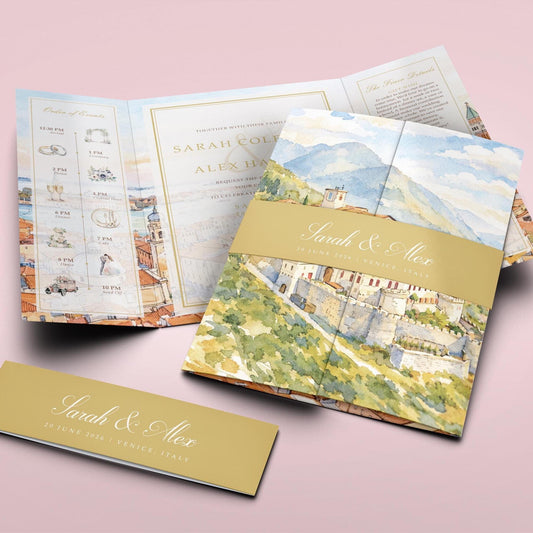 a wedding invitation with a watercolor illustration of a castle and mountains, along with details about the event.