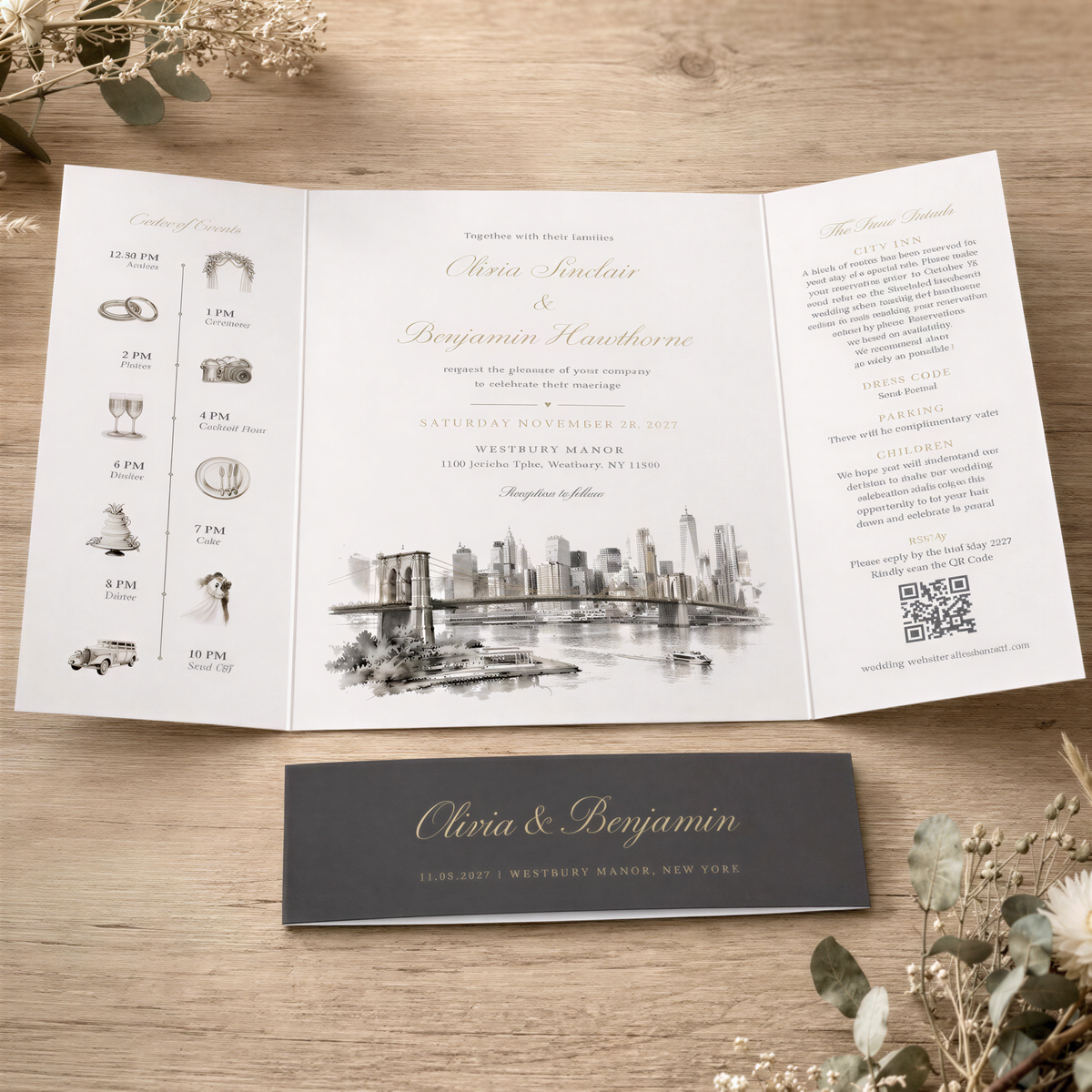 A wedding invitation featuring the names "Olivia & Benjamin" and a cityscape illustration, placed on a wooden surface with a black and white photograph of the Westbury Manor in New York City in the foreground.