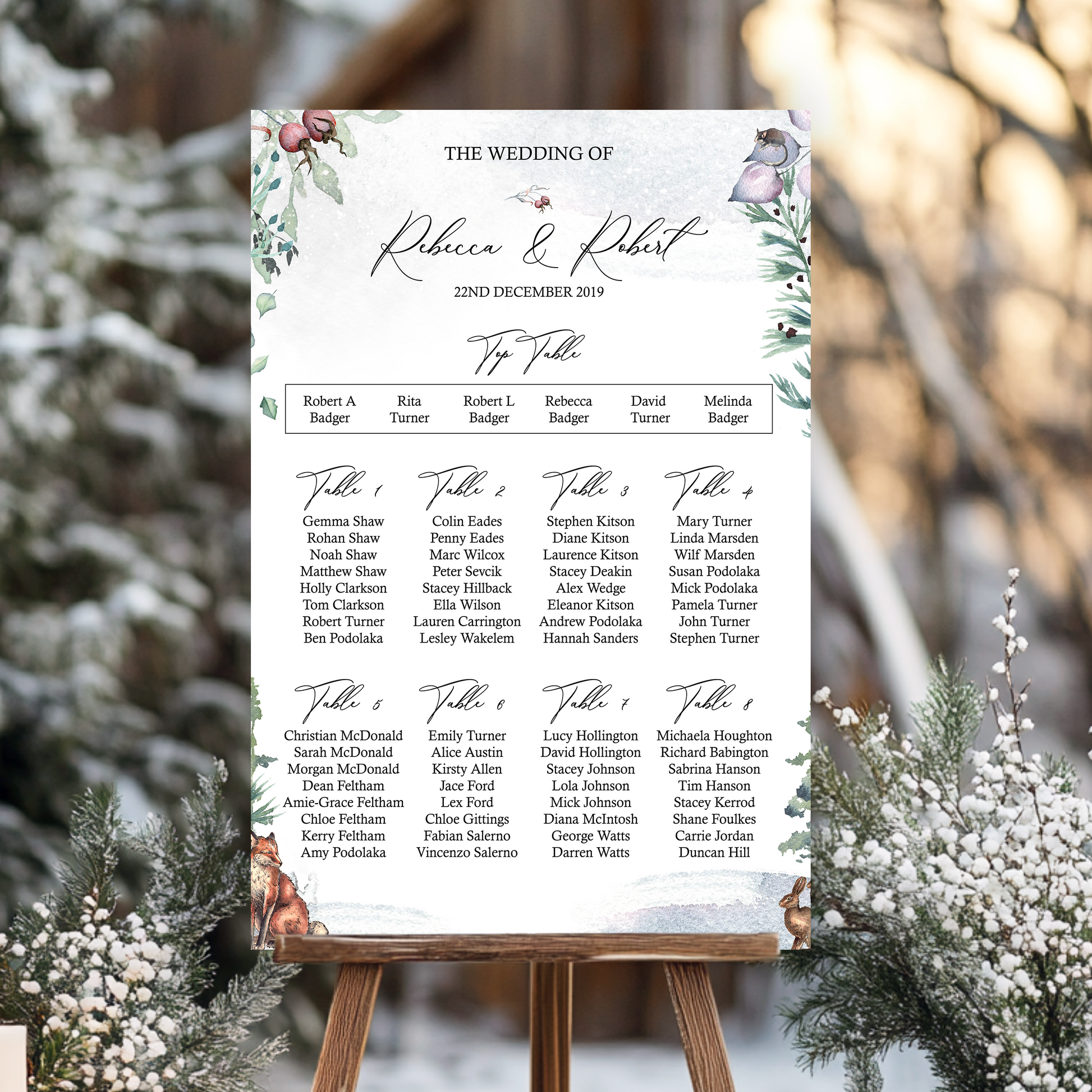 Wedding seating chart on an easel with winter scenery perfect for a winter wedding or Christmas wedding