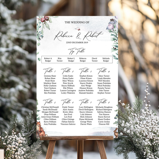 Wedding seating chart on an easel with winter scenery perfect for a winter wedding or Christmas wedding