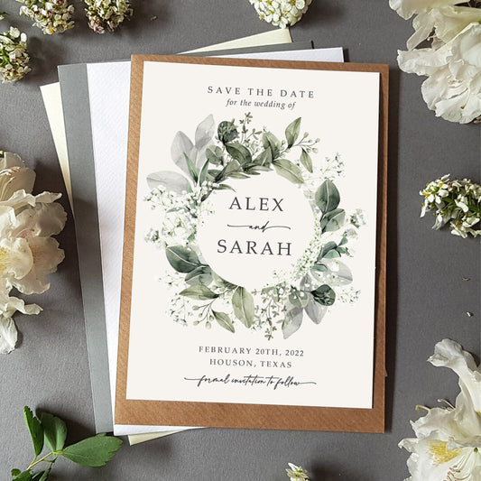Baby&#39;s breath save the date card with a choice of envelopes featuring an array of gypsophila and eucalyptus greenery in a wreath