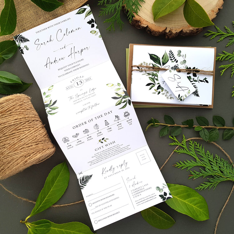 Greenery wedding invitations set with personalised tag, rustic twine and a choice of envelopes. Featuring an array of leafy greenery with iniitals in the middle and calligraphy font